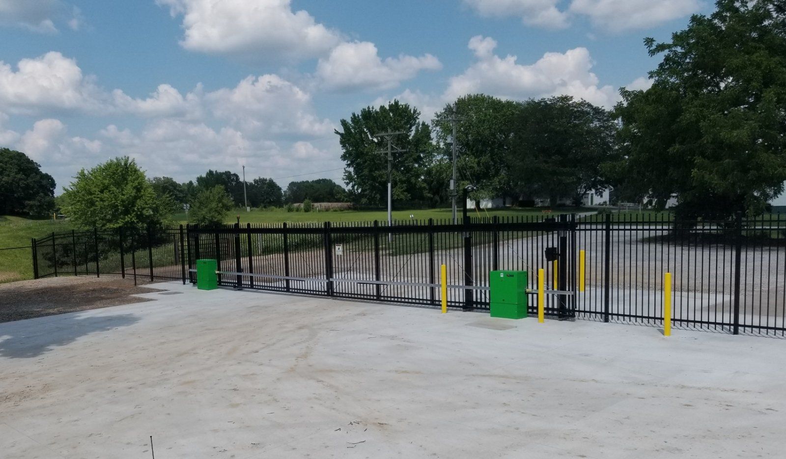 A black fence with a green box in front of it