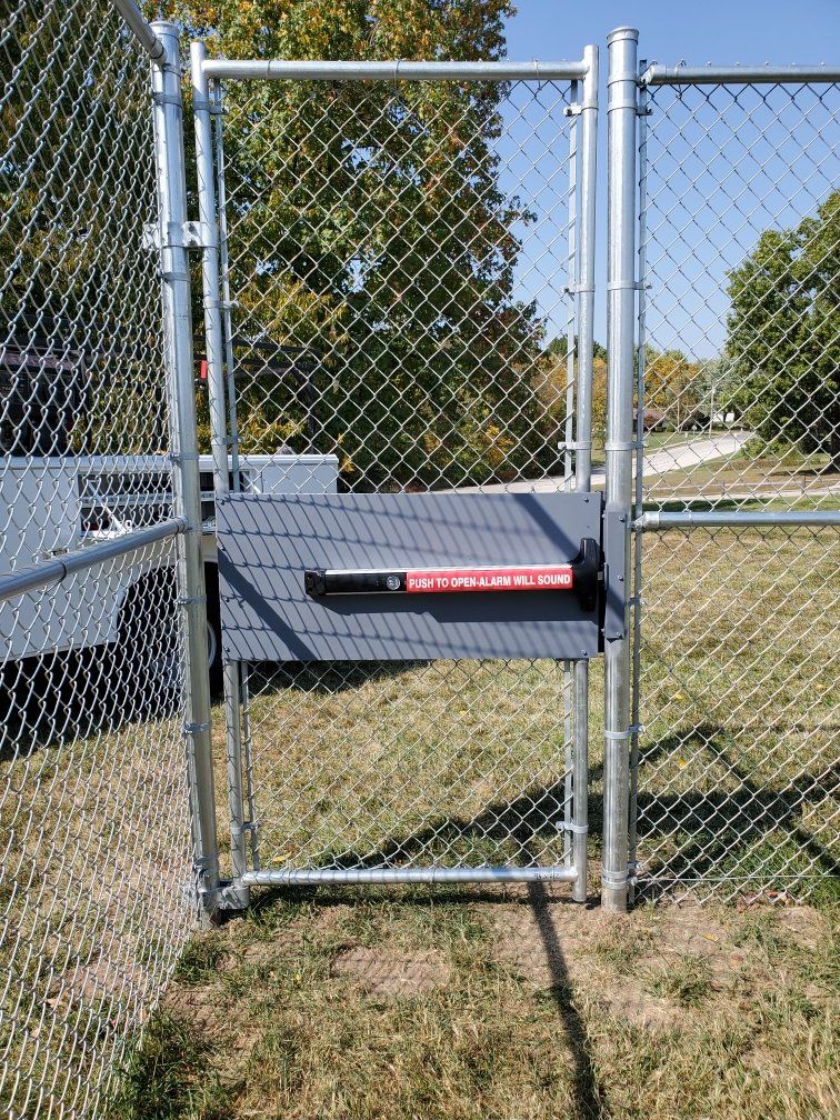 A chain link fence with a gate attached to it.