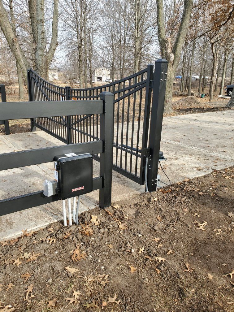 A black gate with a motor attached to it is open.