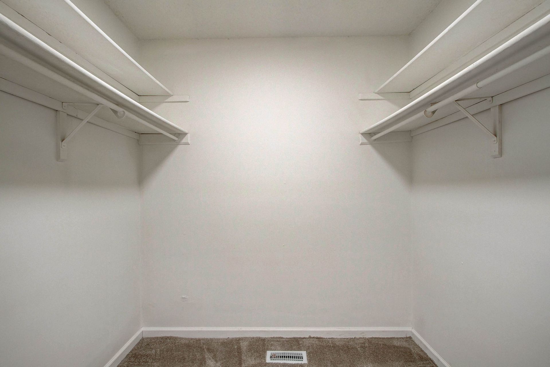 Empty white closet with two shelves.