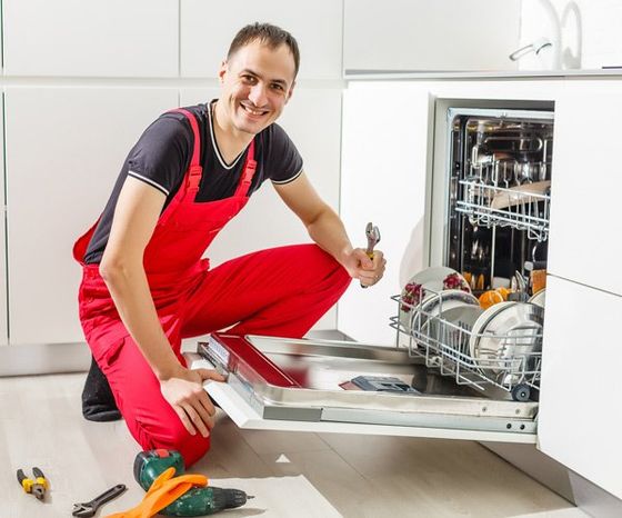 Appliance Repair — Young Male Technician Repairing Dishwasher in Salem, NH