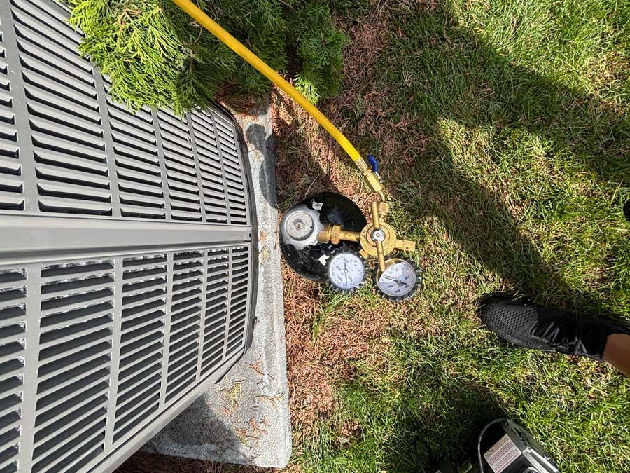Servicing HVAC System Unit — America NW Plumbing, Heating, and Cooling in Post Falls, ID