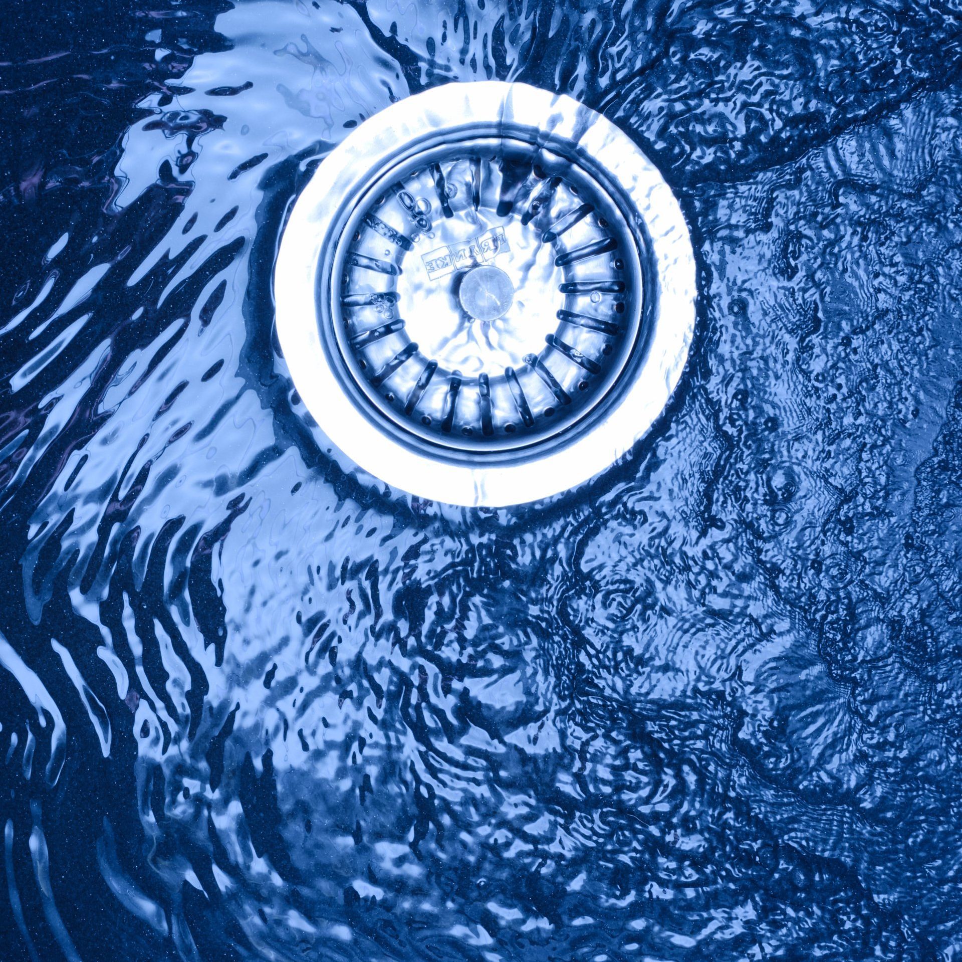 White electric water heater mounted on a tiled wall.