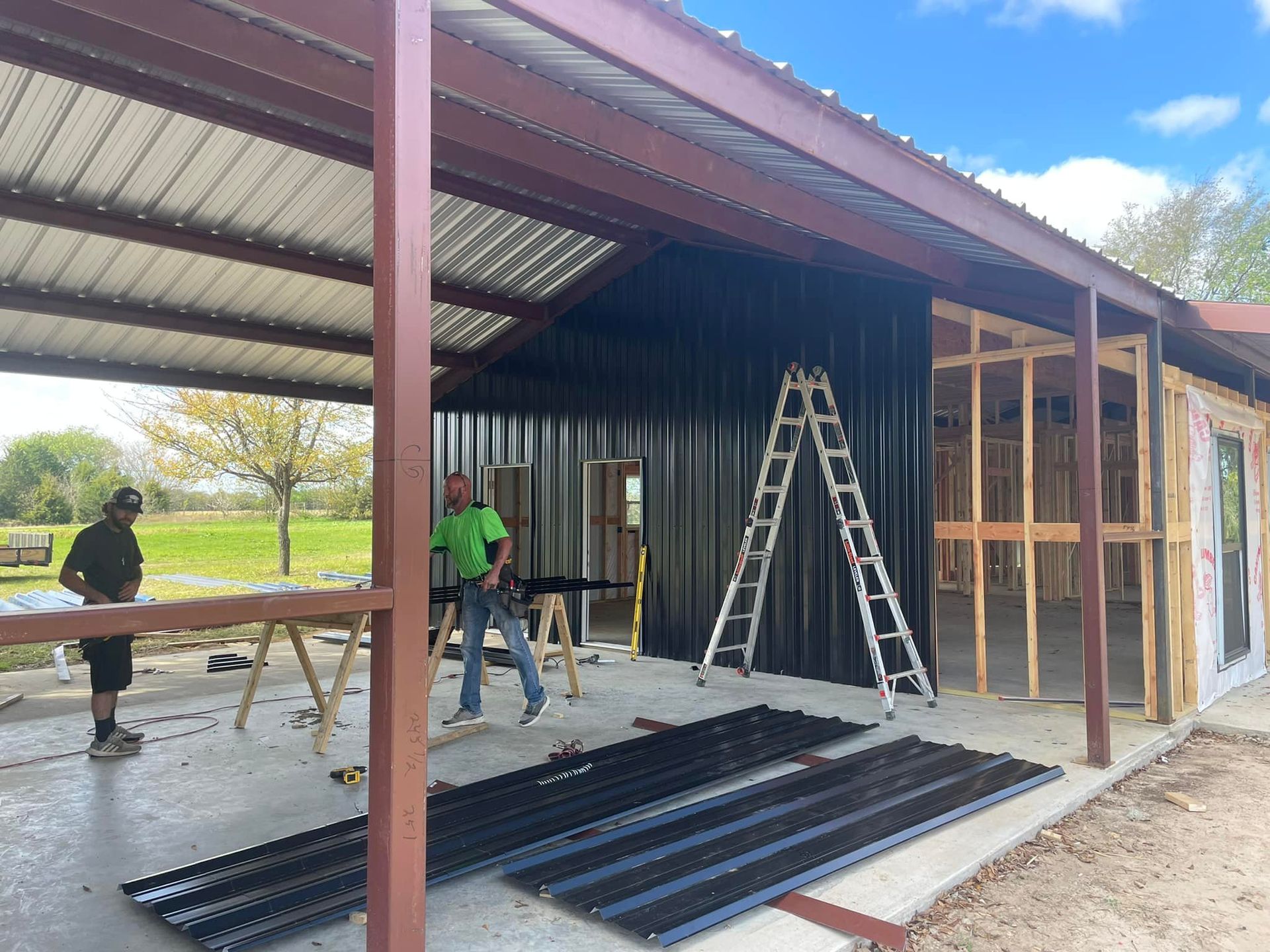 A man is standing in front of a building under construction.