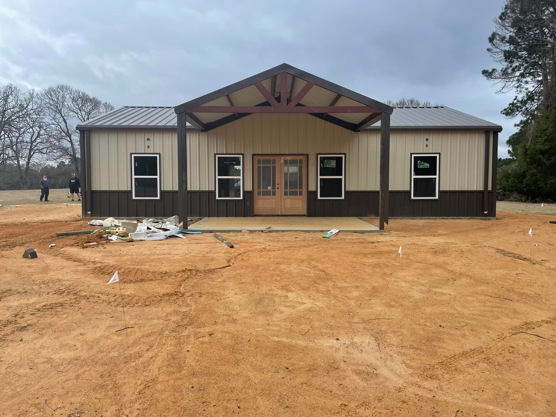 A house is being built in the middle of a dirt field