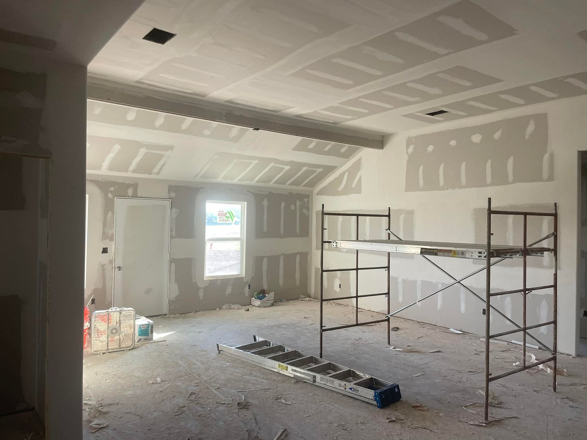 A room with a ladder and scaffolding in it