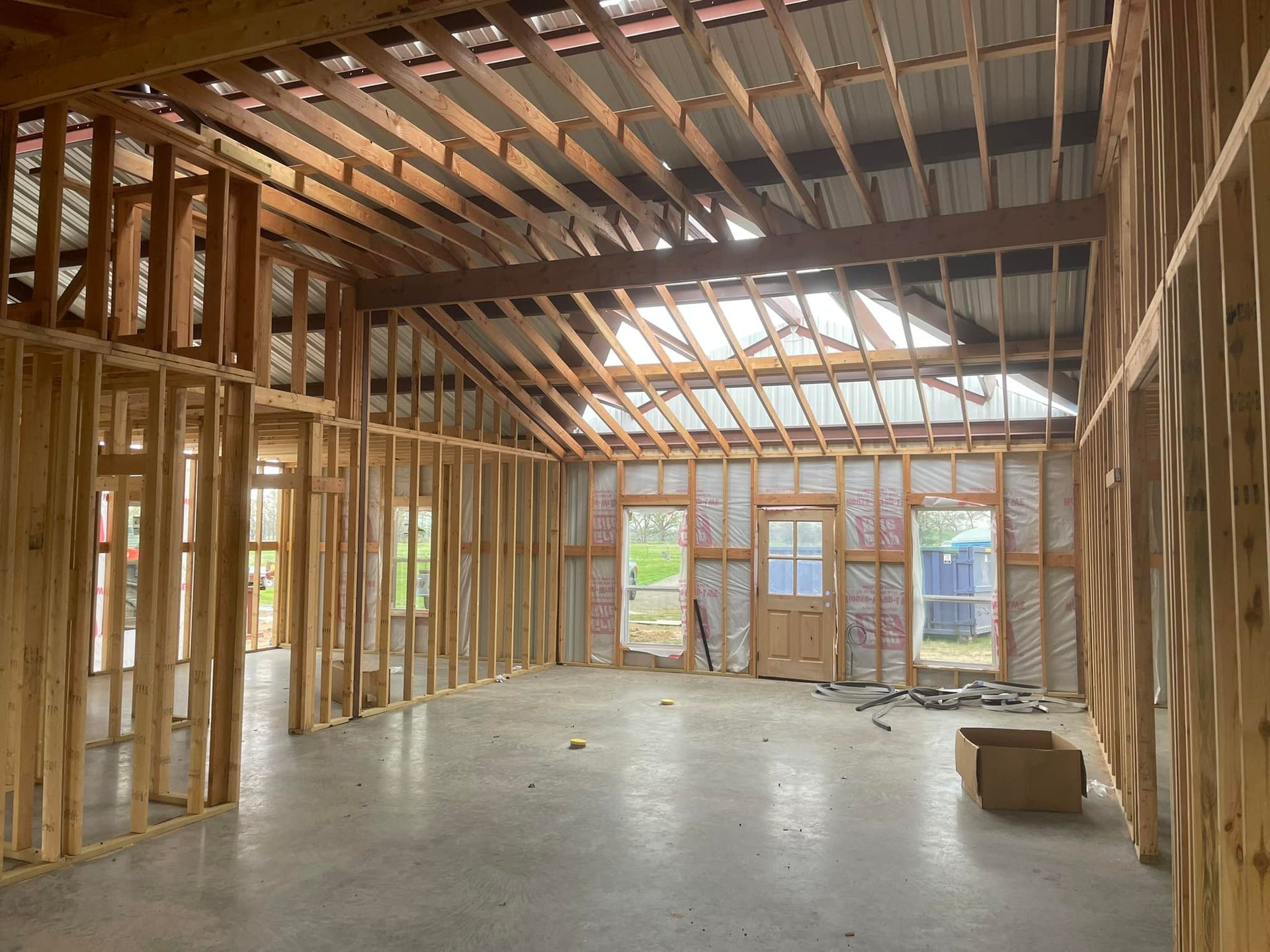 The inside of a building under construction with a box on the floor.