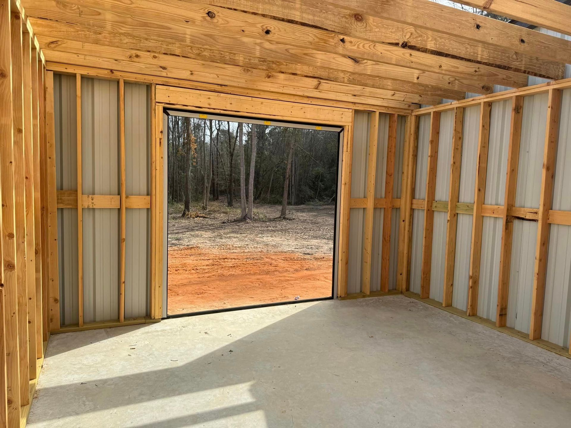 A garage under construction with a large garage door.