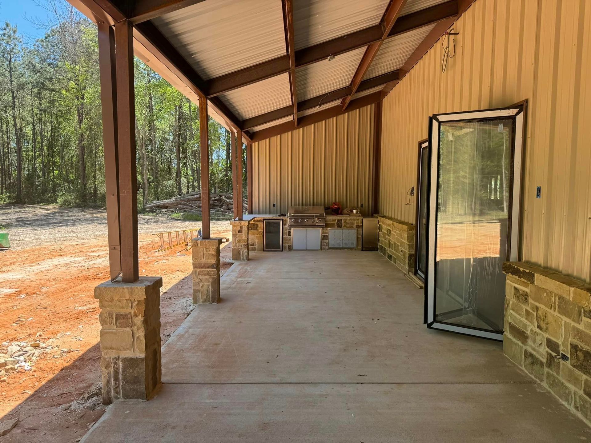 There is a porch with a roof and a door.