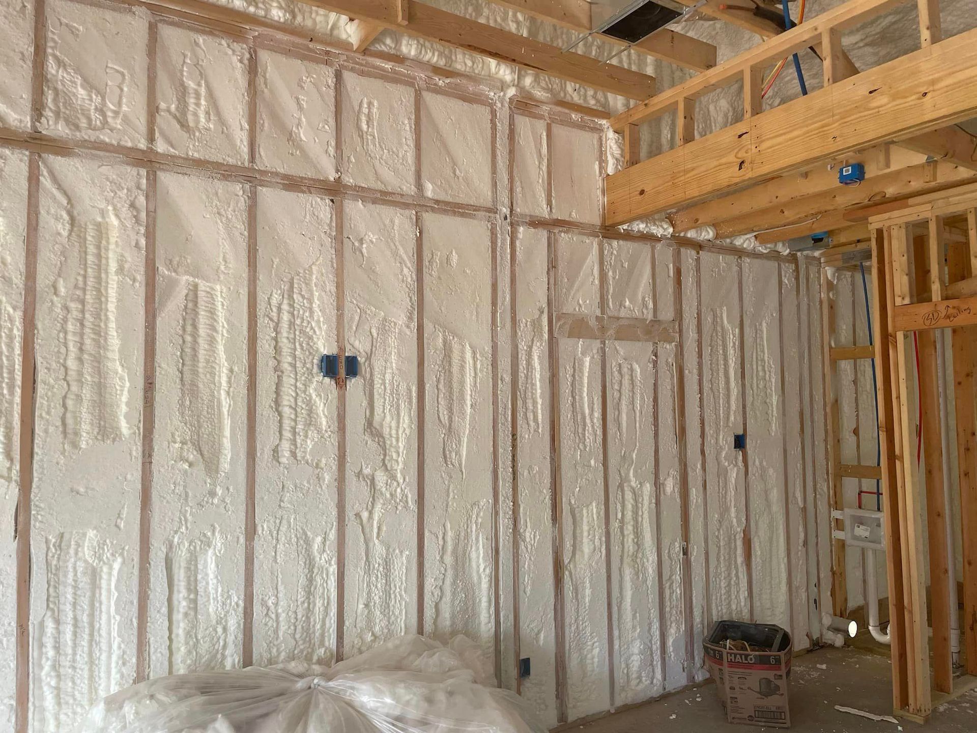 A room in a house under construction with a lot of foam on the walls.