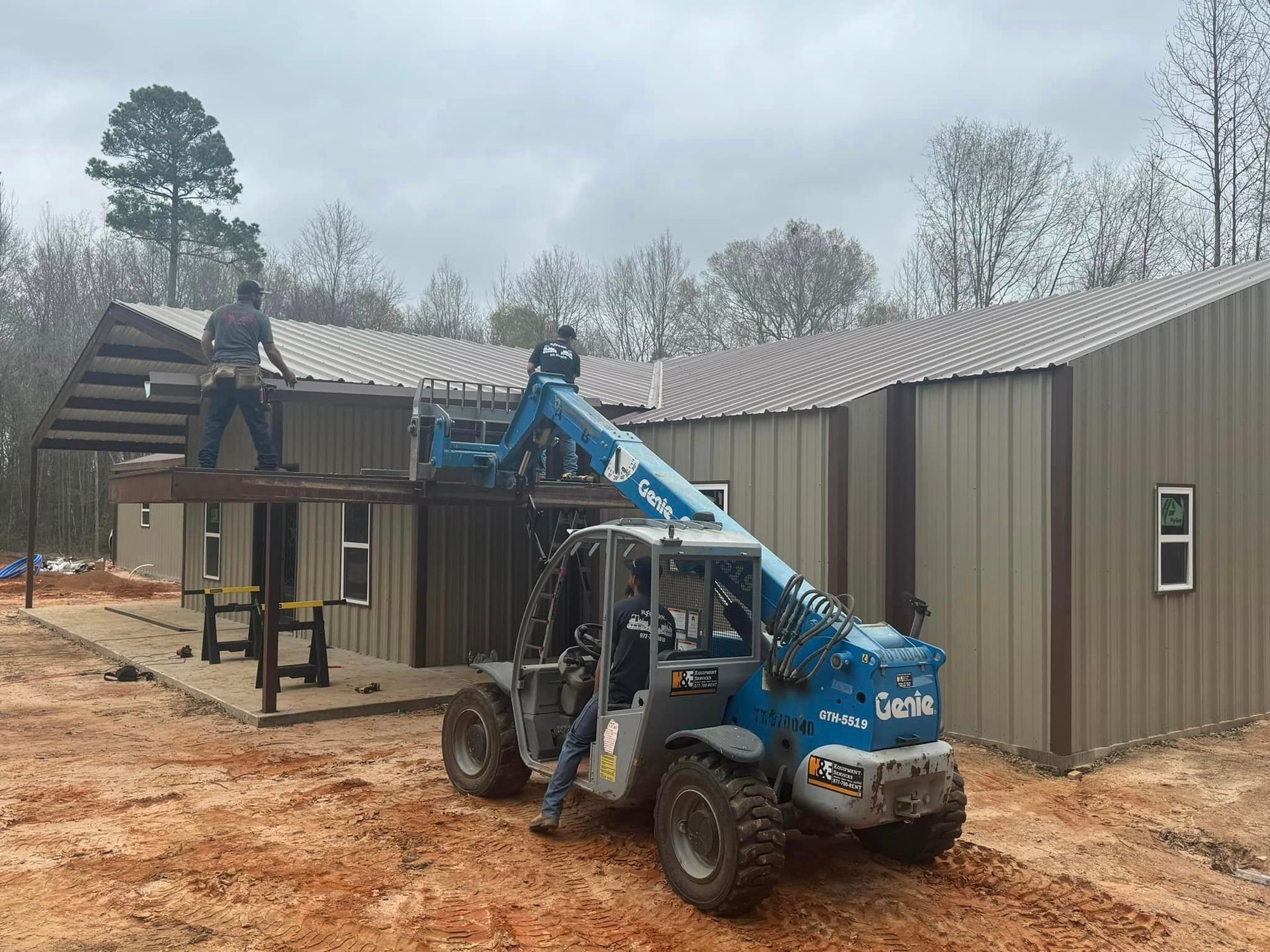 A man is working on the roof of a building with a forklift.