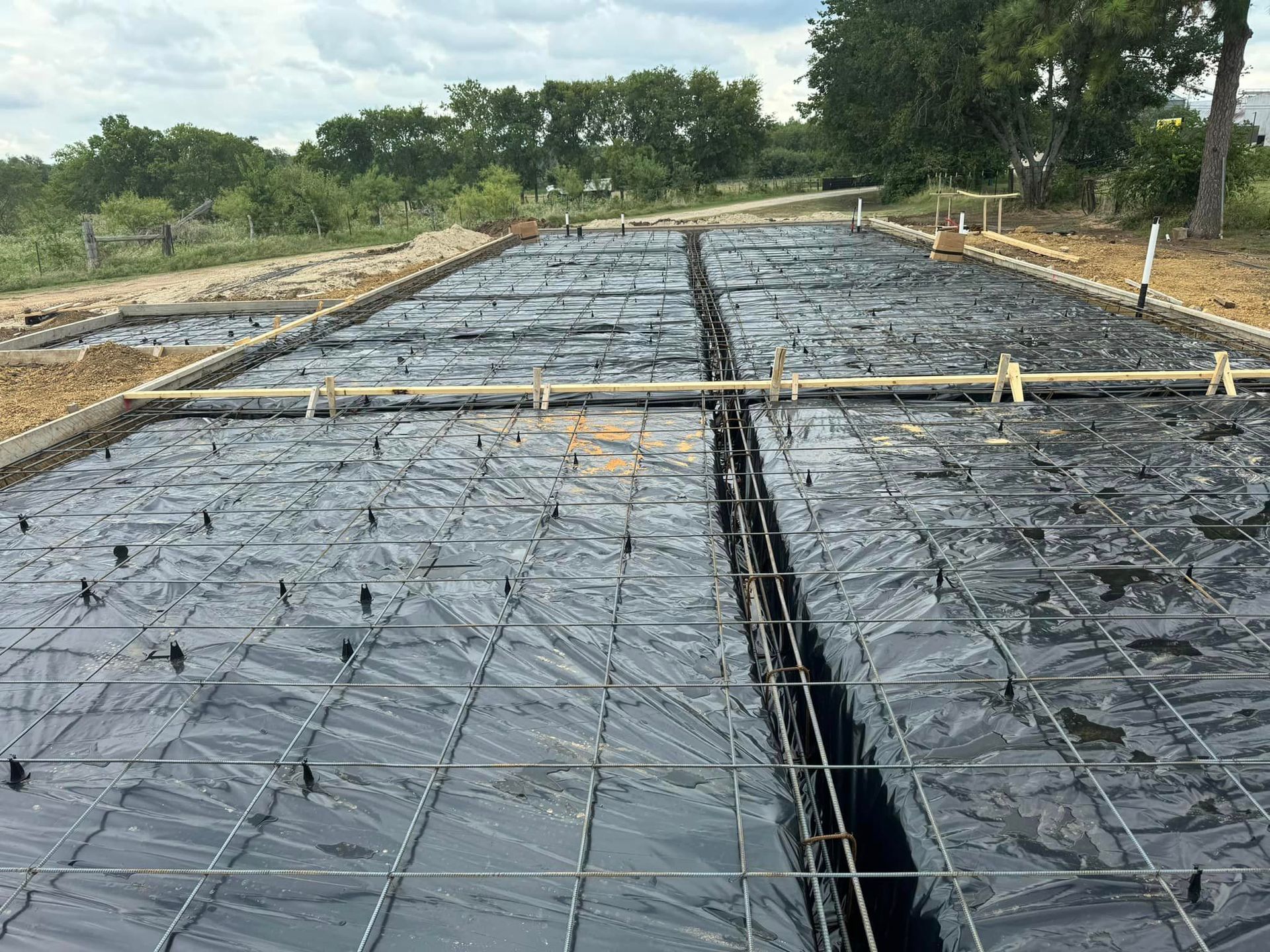 A concrete floor is being built on a construction site.