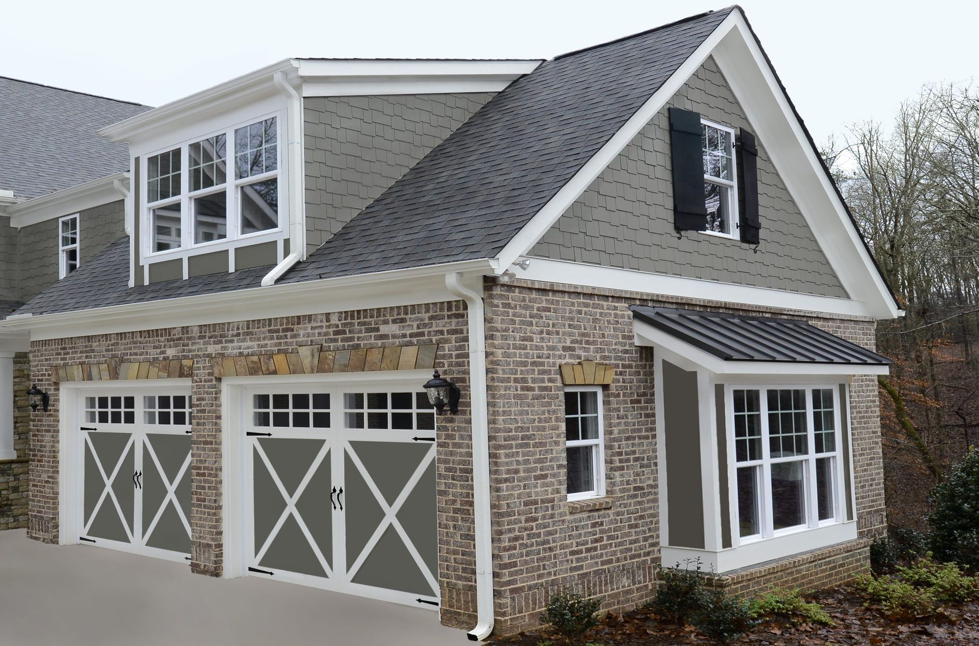 A house with two garage doors and a large window