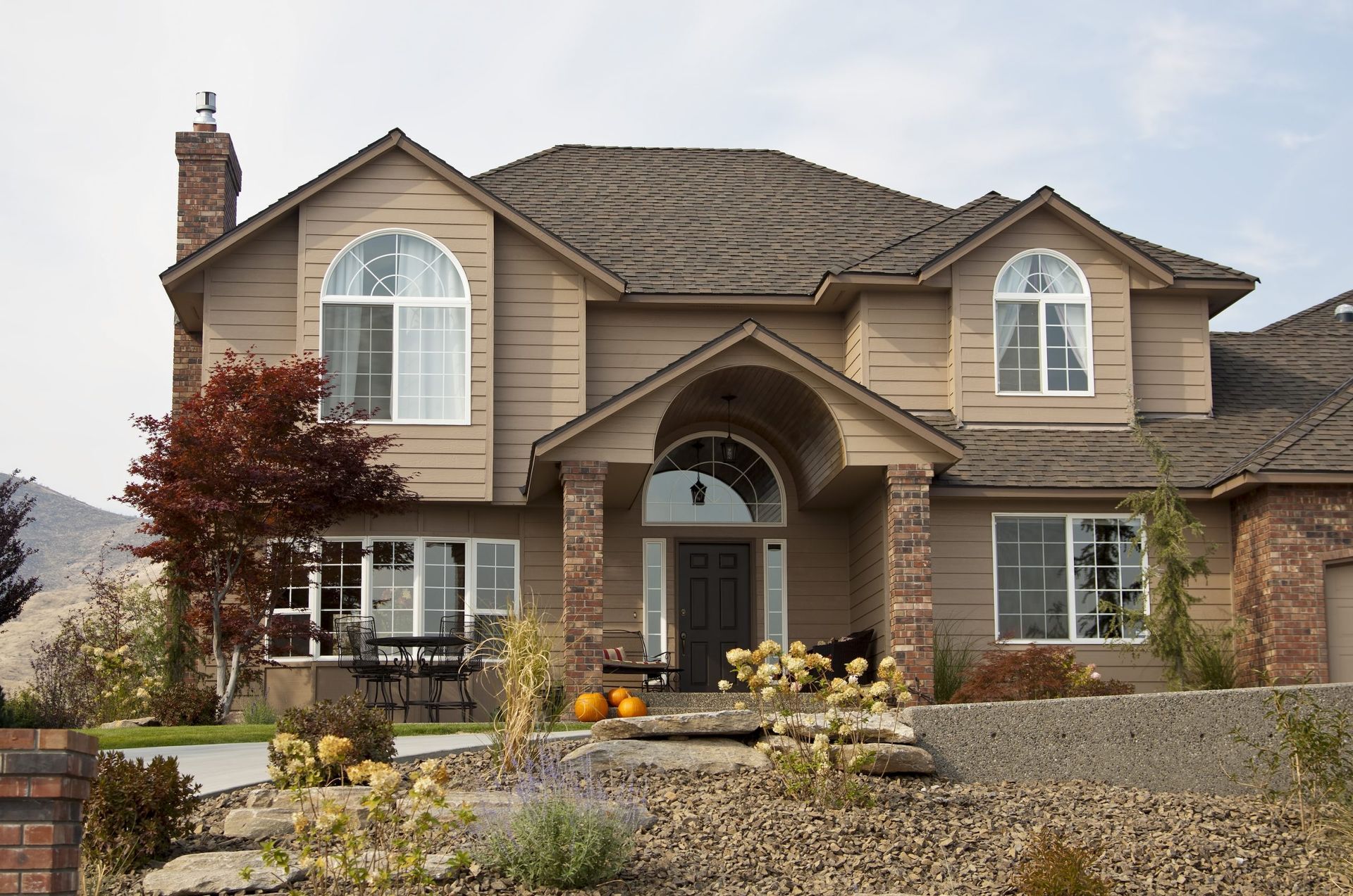 A large house with a slate roof and arched windows