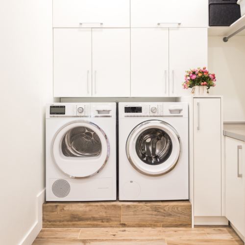 A laundry room with a washer and dryer in it