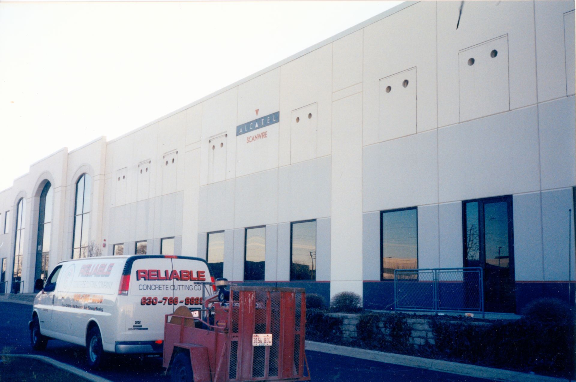 A reliable van is parked in front of a building