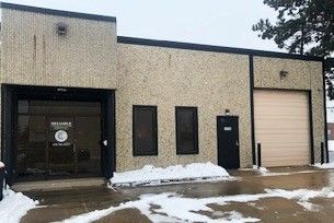 A large building with a lot of snow on the ground in front of it.