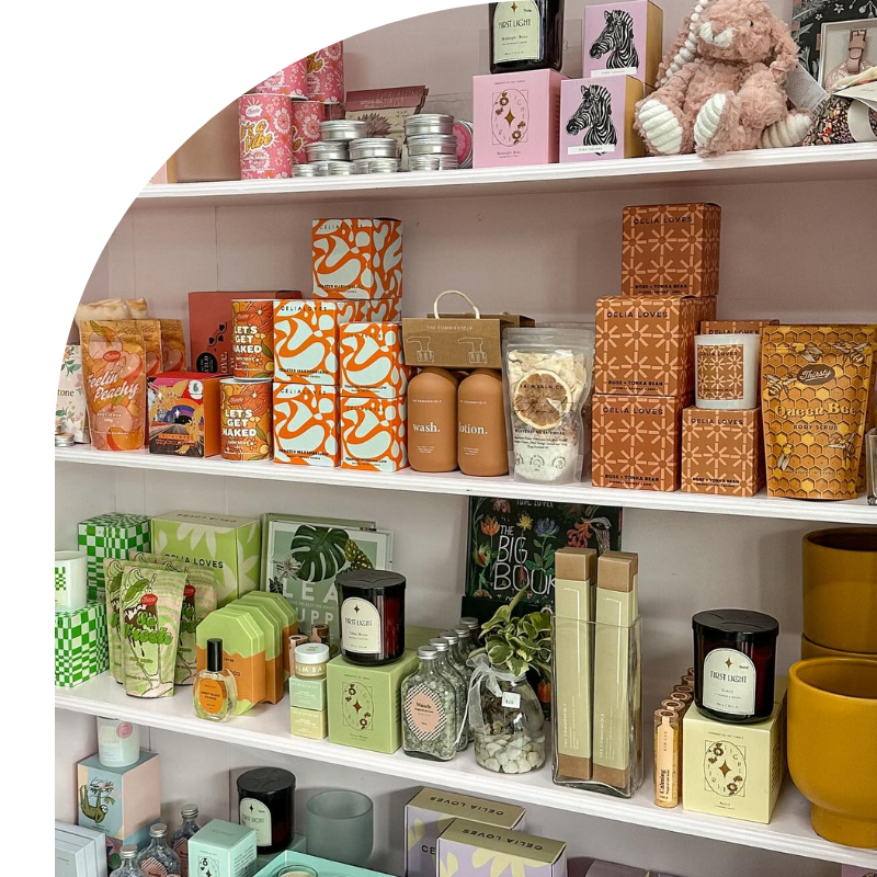 A Bag Of Bath Salts Is Sitting On A Table Next To Grapes And A Candle Holder — Mittagong Flower Merchant in Mittagong, NSW