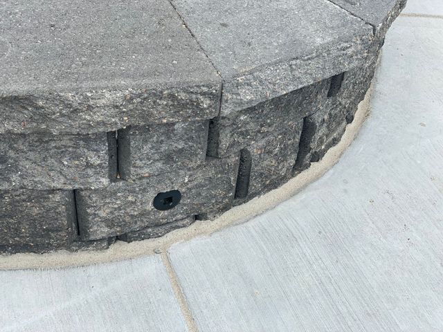A close up of a stone wall with a hole in it