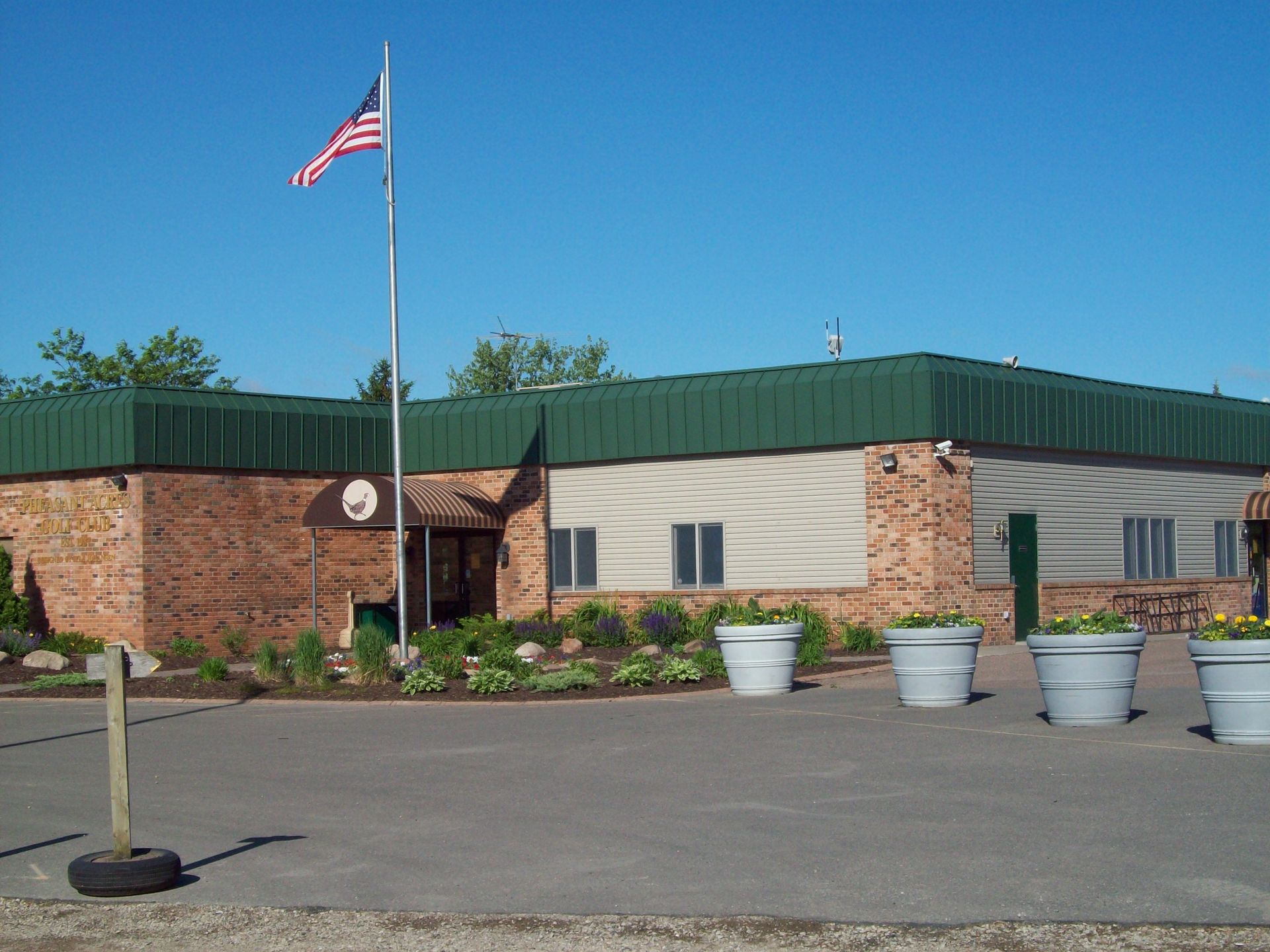An american flag is flying in front of a brick building