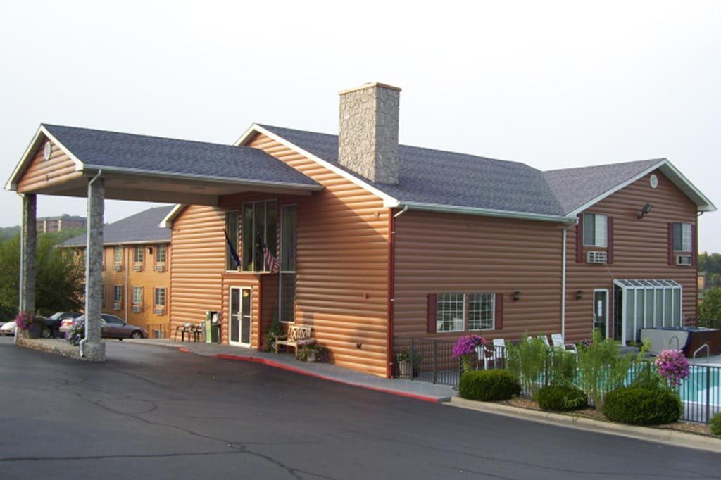 A large house with a swimming pool in front of it