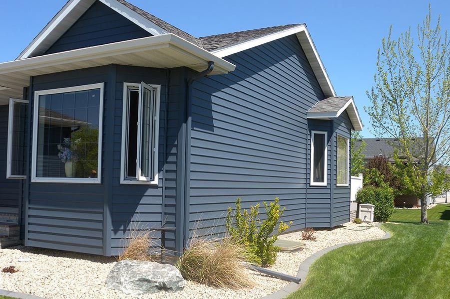 A blue house with white trim and a lot of windows