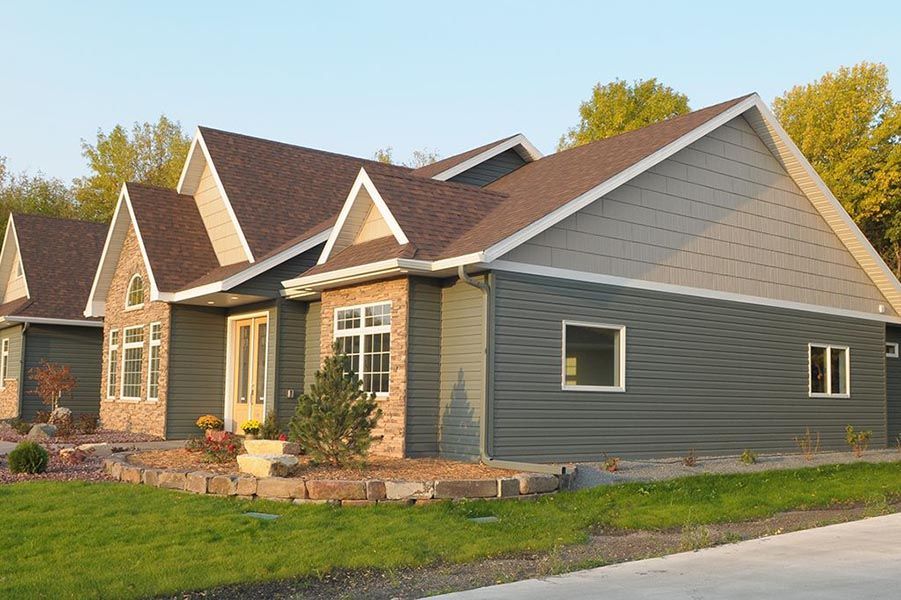 A large house with a lot of windows and a brown roof