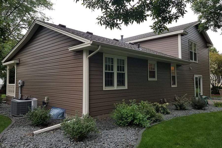 The back of a house with a lot of windows