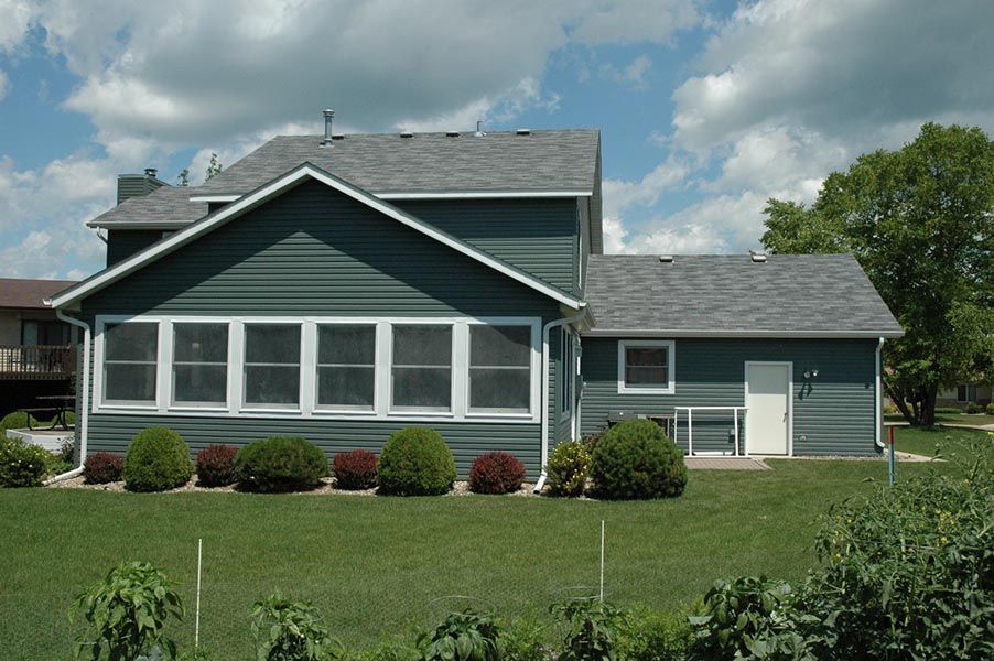 A house with a lot of windows and a gray roof