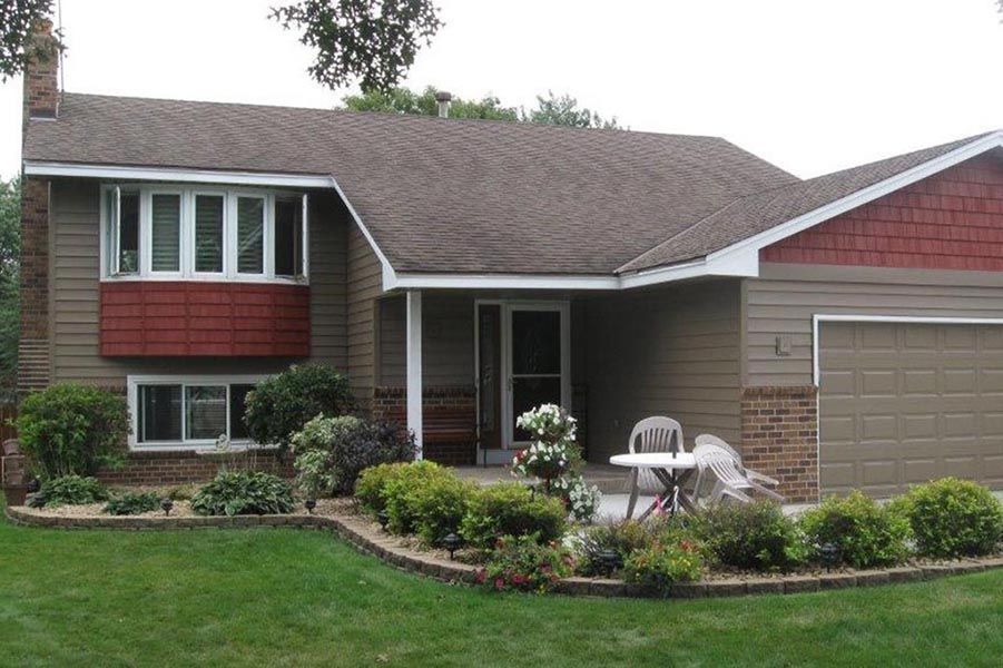 A house with a table and chairs in front of it