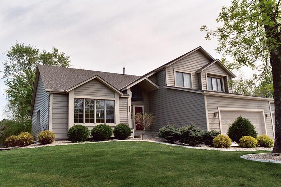 A house with a large lawn in front of it