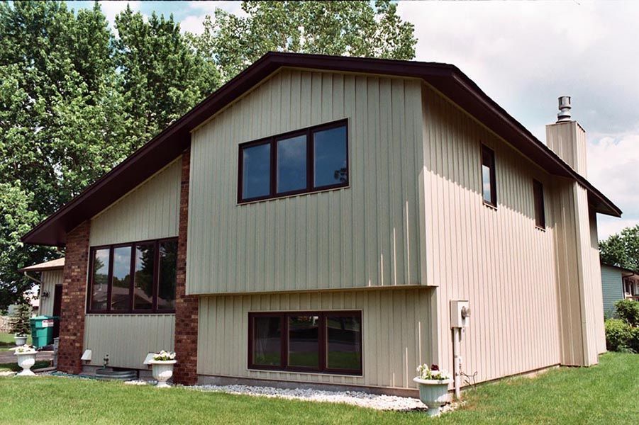 A house with a lot of windows and a chimney