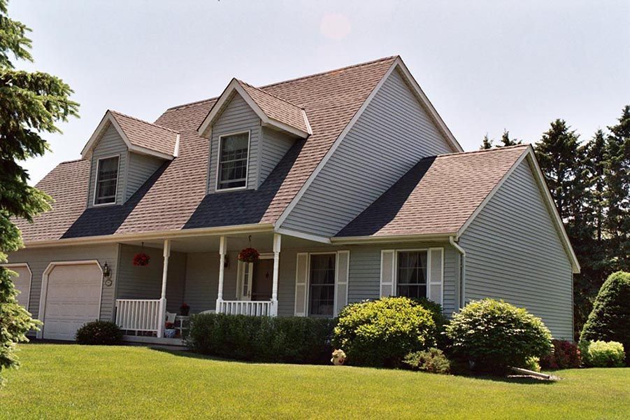 A large house with a porch and a garage