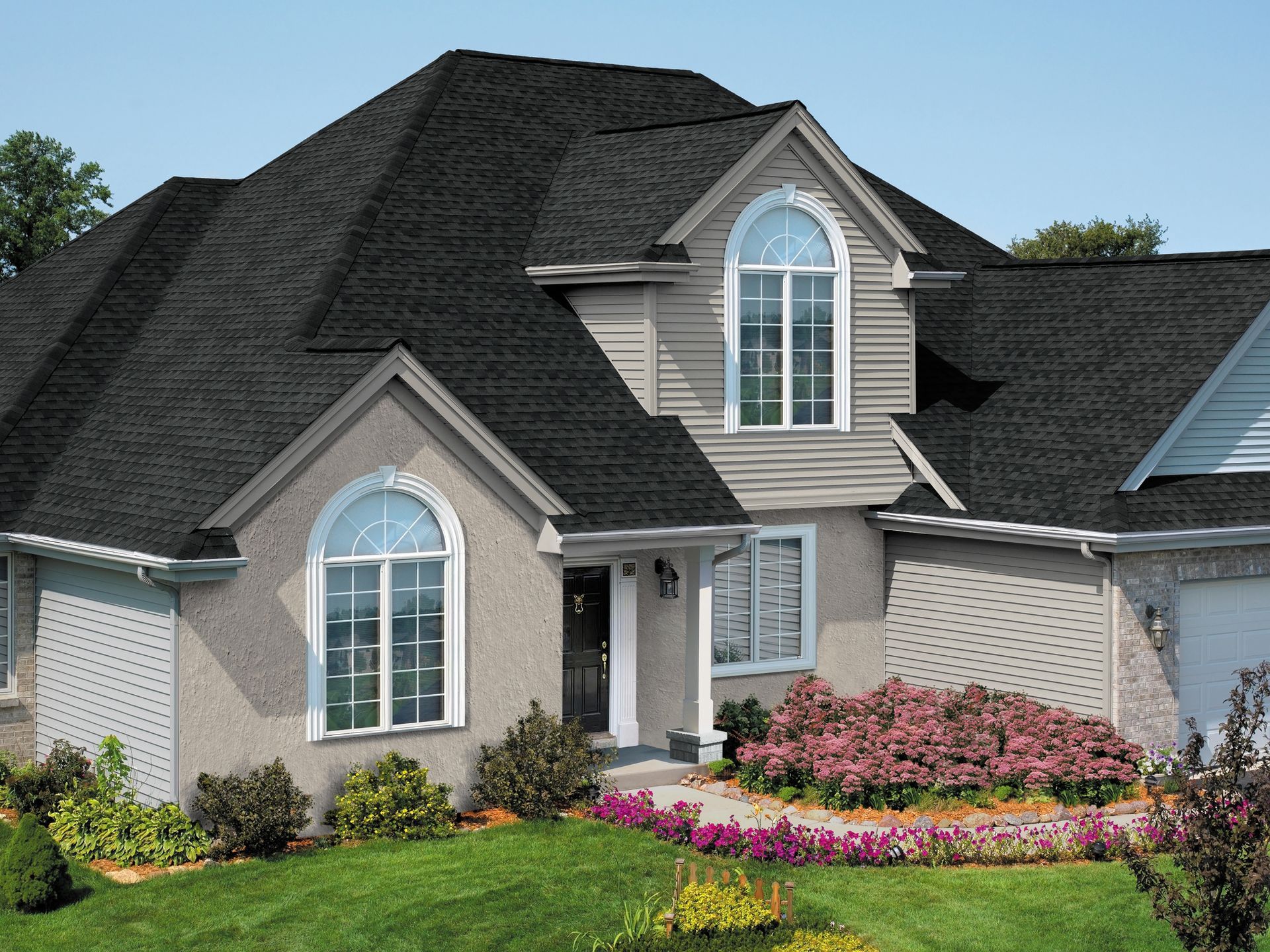 A house with a black roof and arched windows