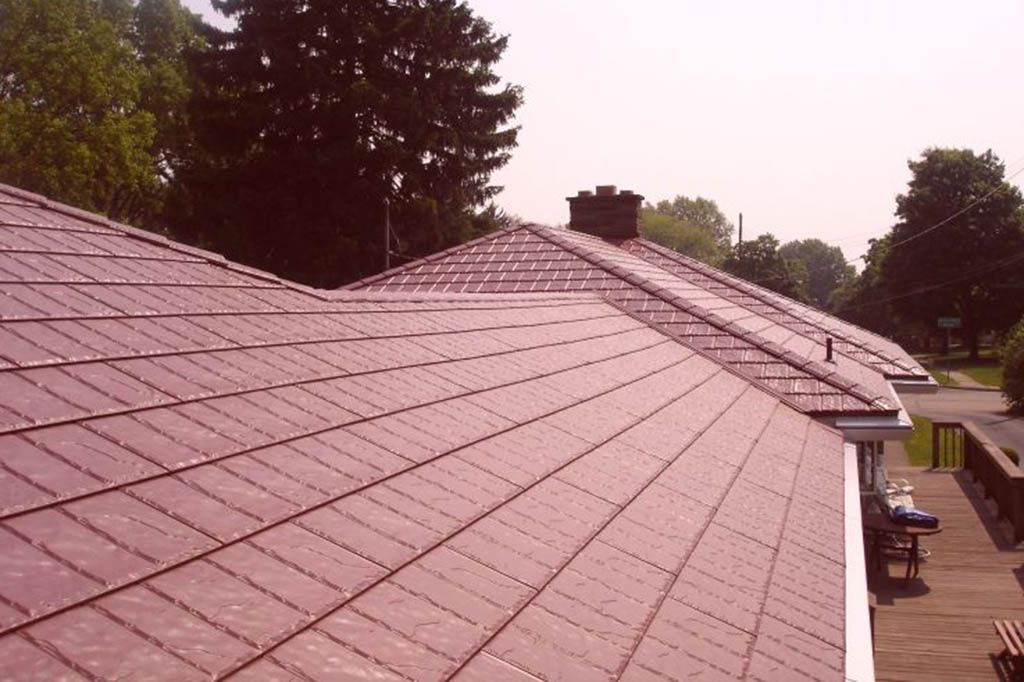 A house with a purple roof and trees in the background