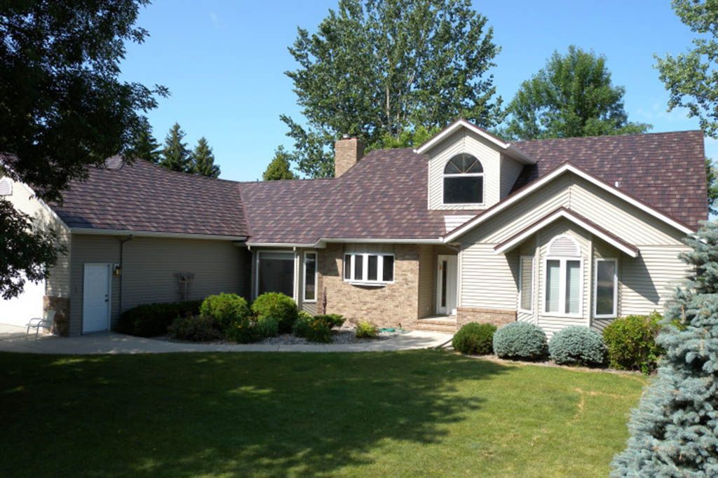 A large house with a purple roof and a lot of windows