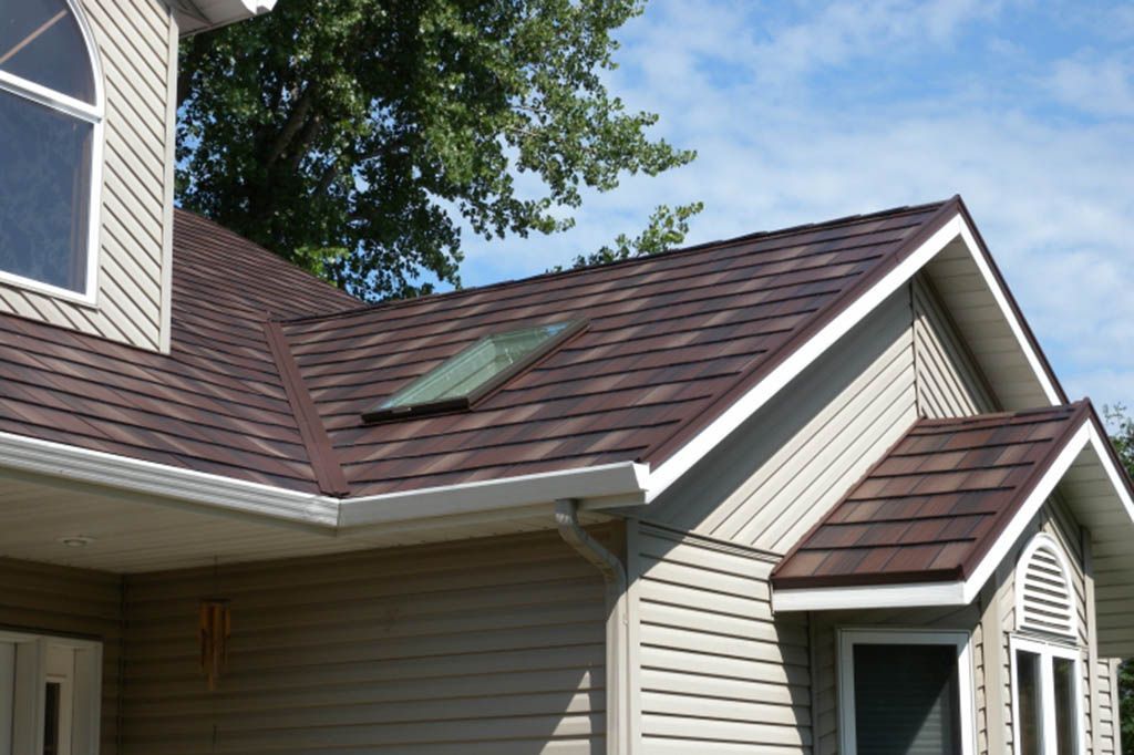 A house with a brown roof and a skylight