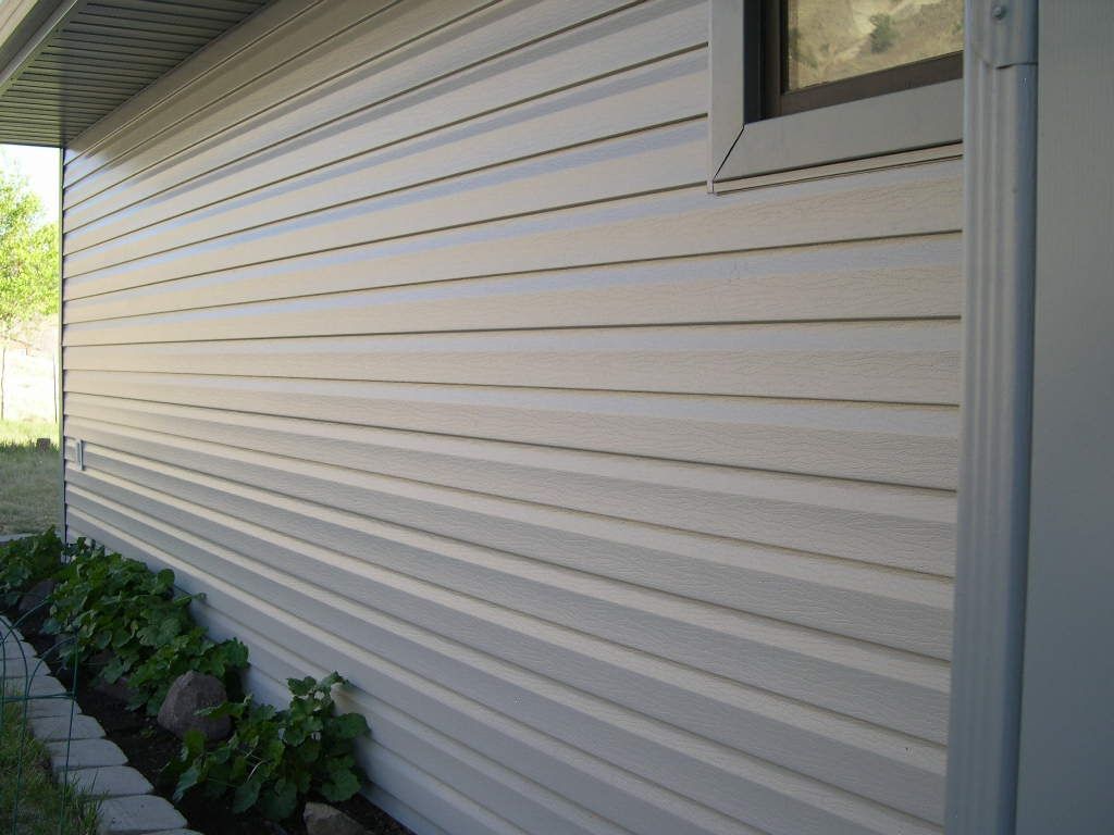 The side of a house with siding and a window