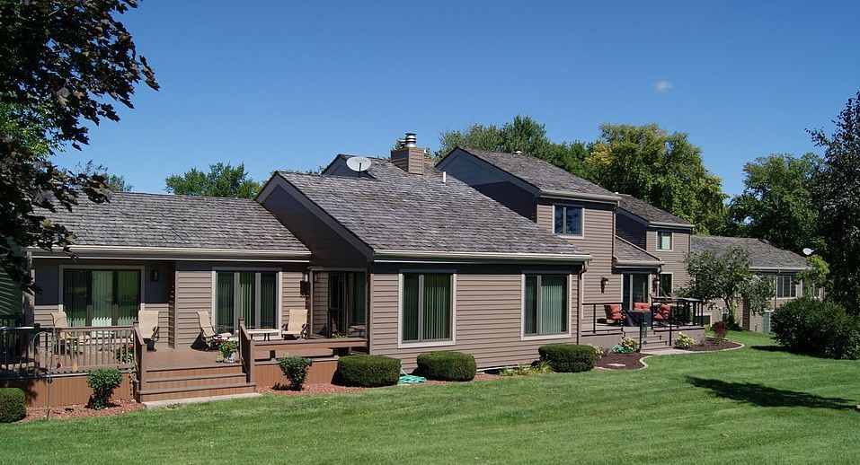 A large house with a large lawn in front of it