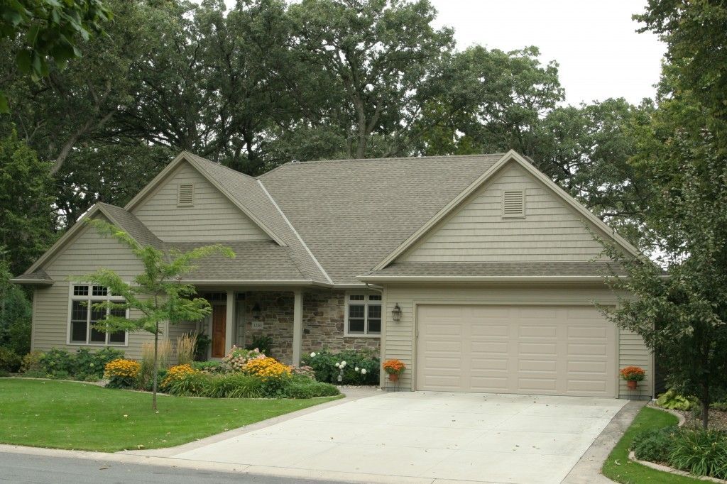 A house with a gray roof and a driveway