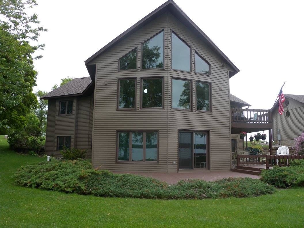 A large house with a lot of windows and a deck