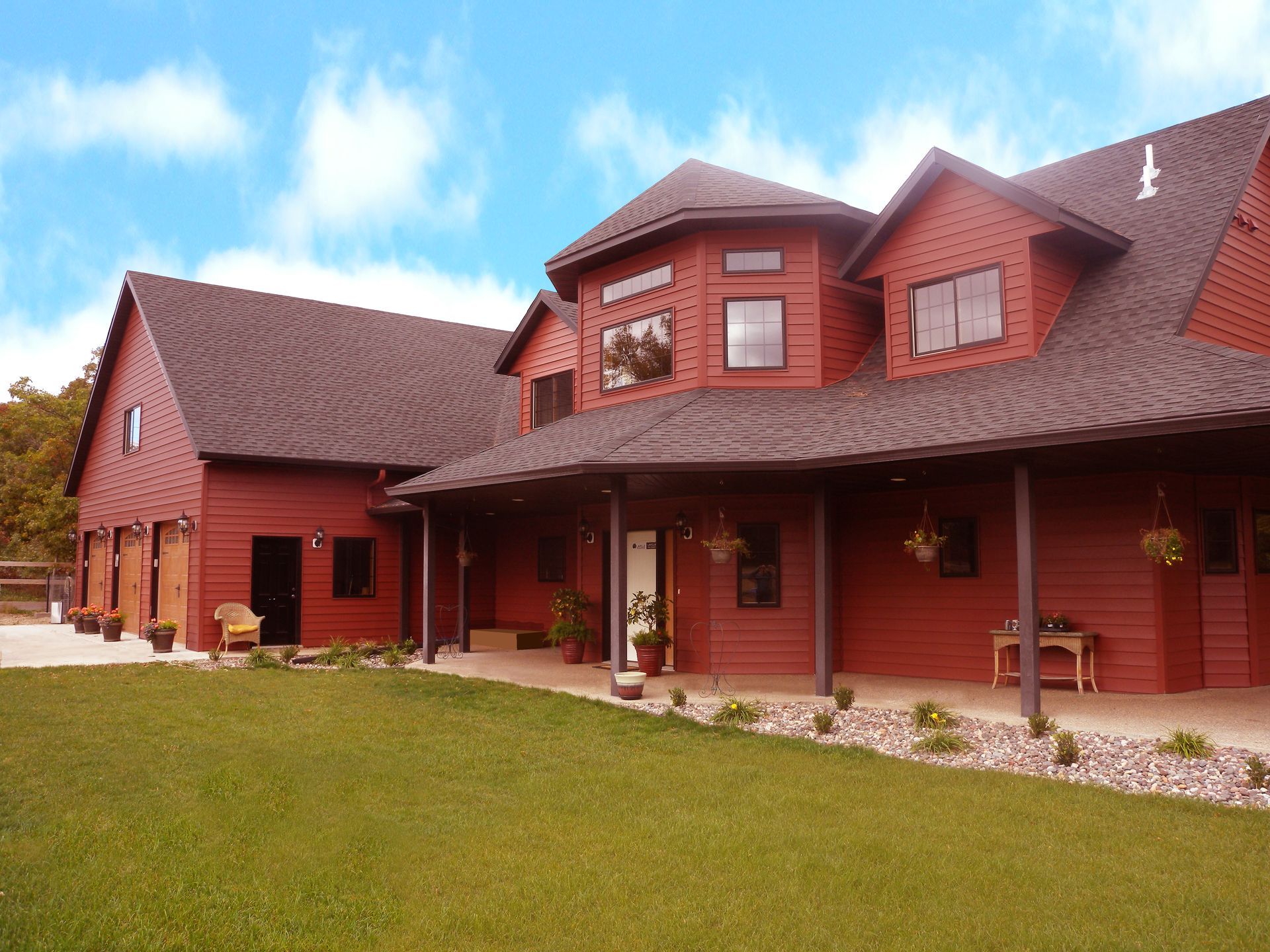 A large red brick house with a large porch