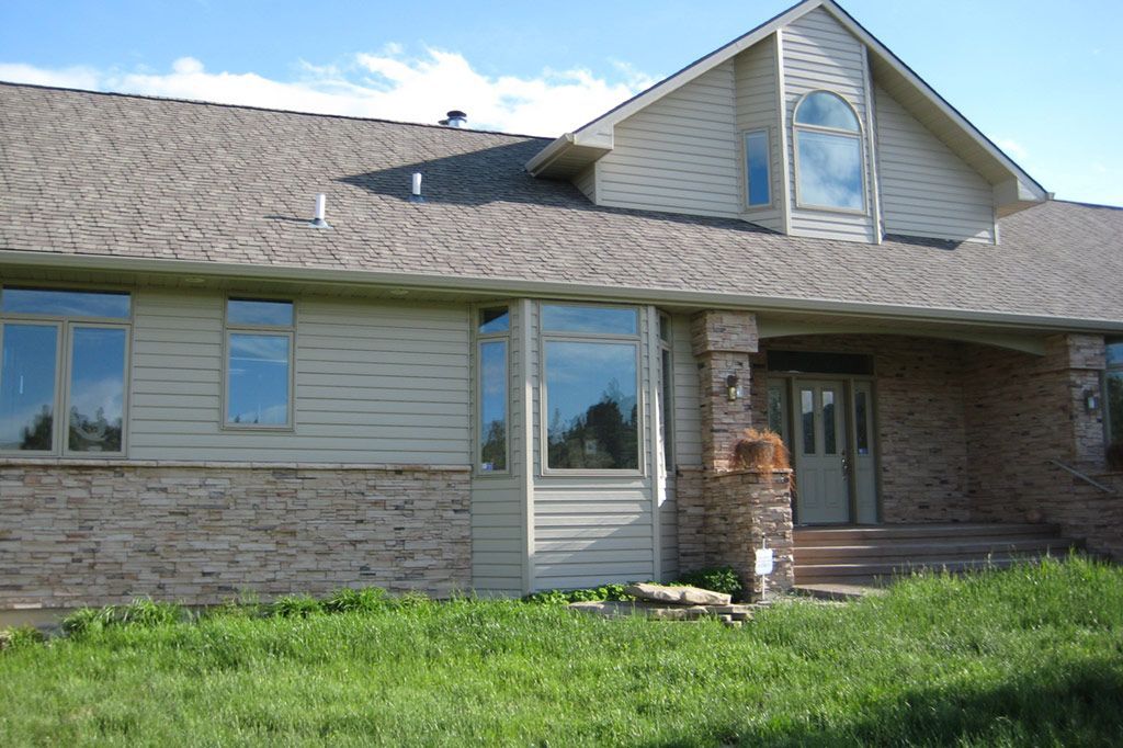 A large house with a lot of windows and a roof
