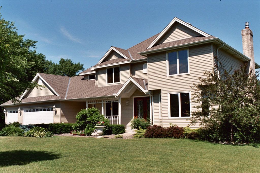 A large house with a lot of windows and a chimney
