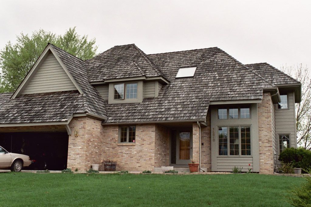A large house with a car parked in front of it