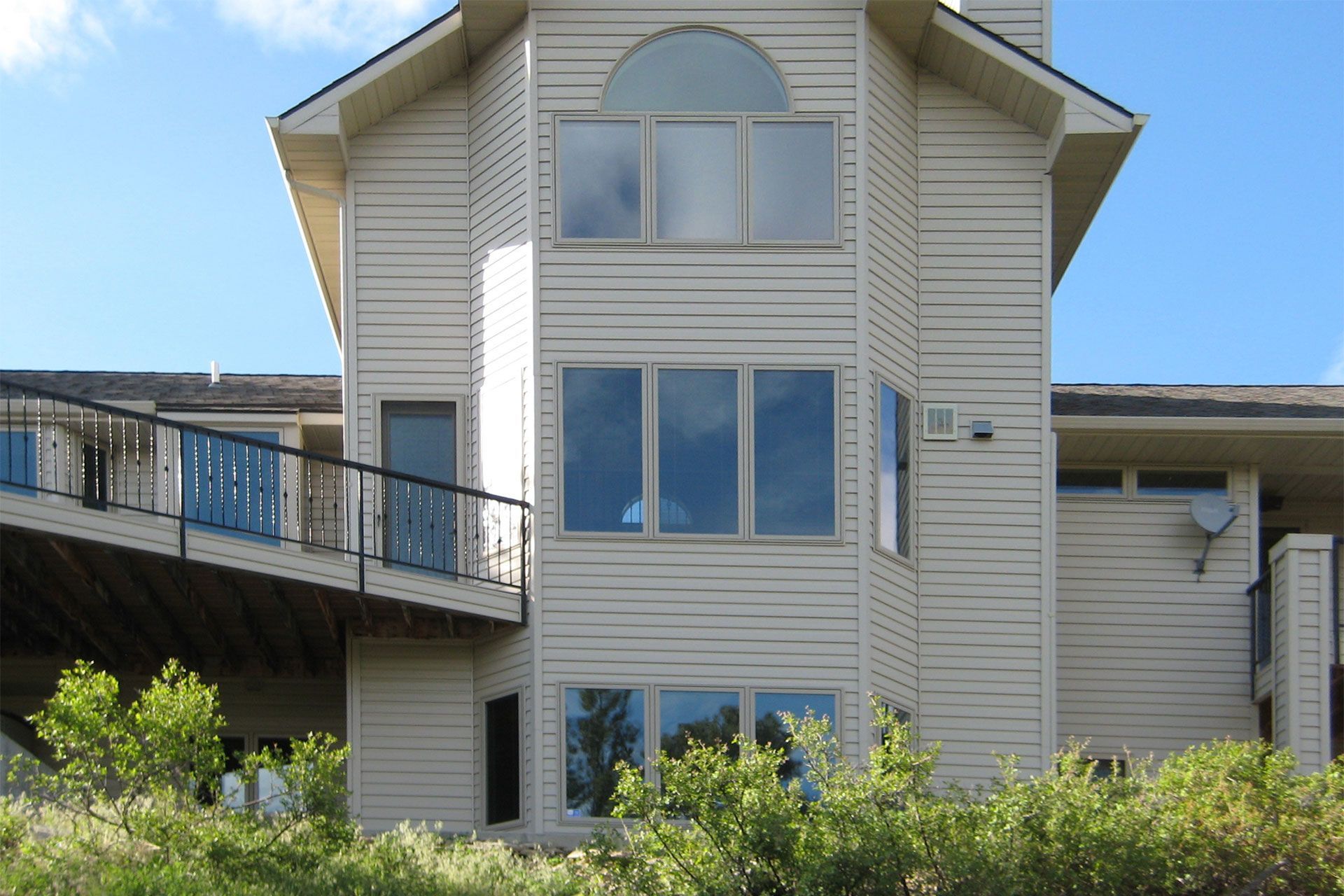 A house with a lot of windows and a balcony