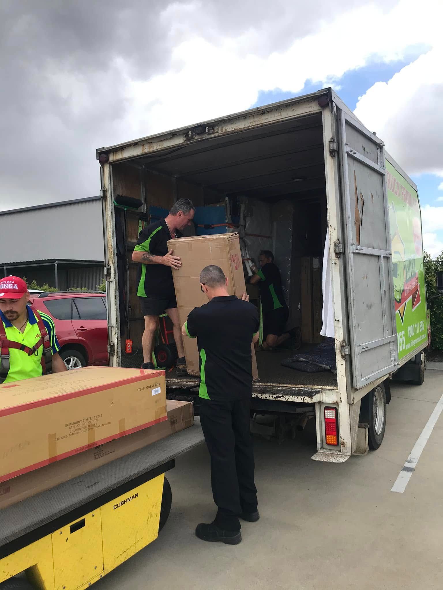 Movers Loading Boxes Into a Truck — Little Green Truck Bundaberg In Childers, QLD
