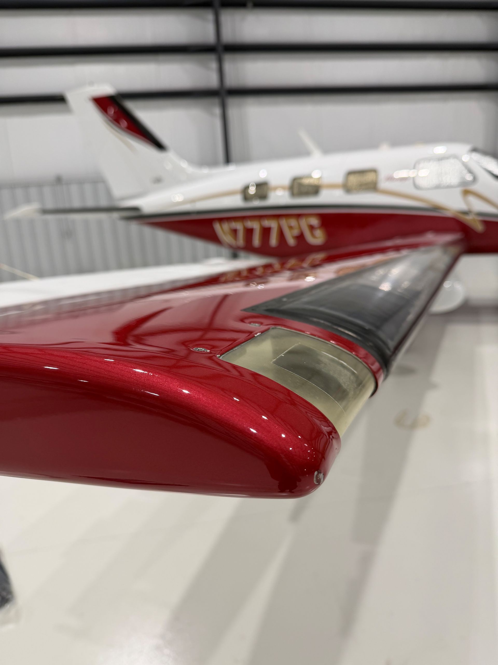 Airplane cabin interior with blue seats, overhead compartments, and windows.