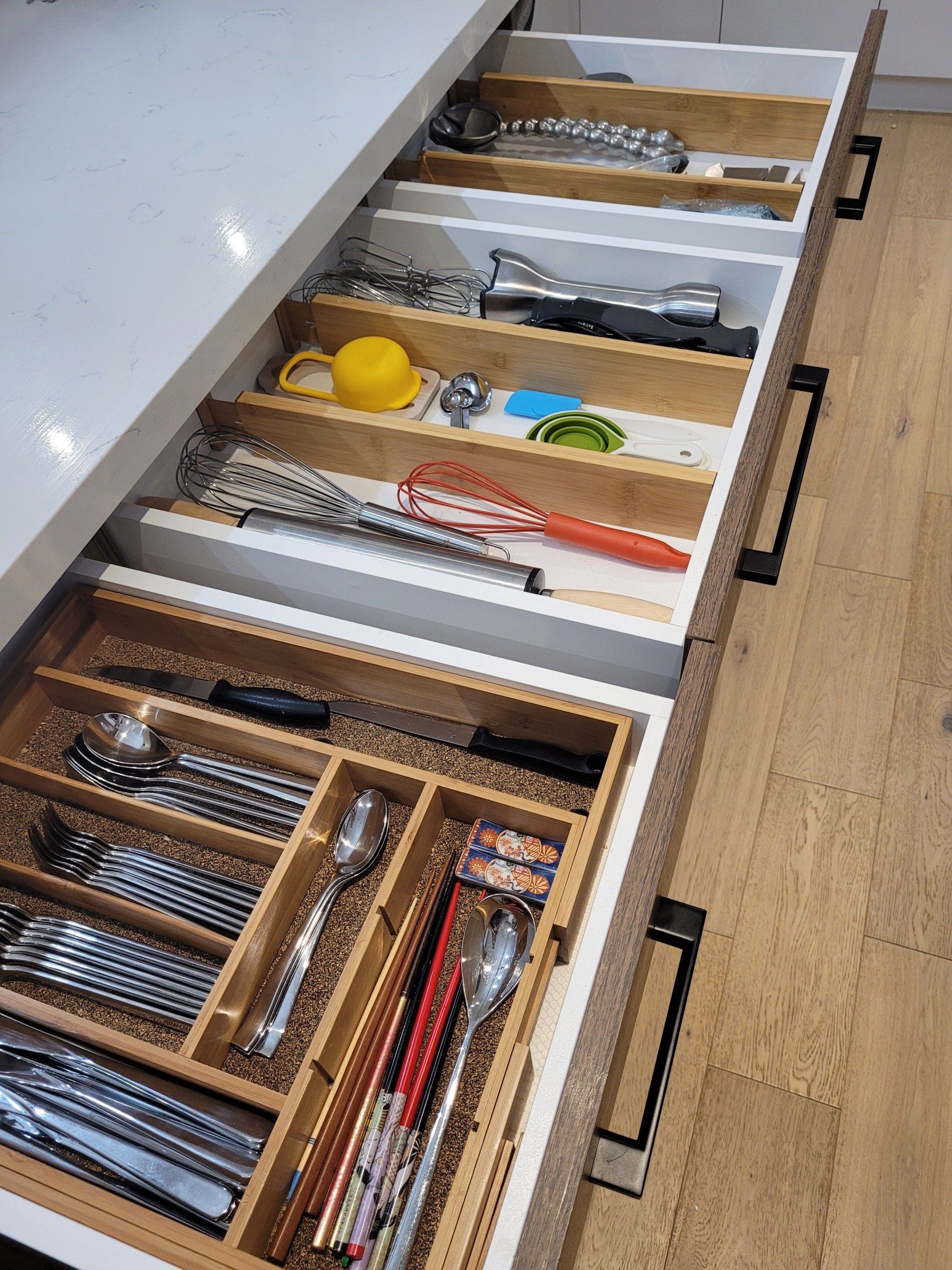 A kitchen drawer filled with utensils and cooking utensils.
