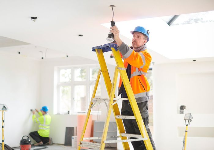 Worker Fixing The Light Bulb Wirings — Santa Ana, CA — A Dan The Handyman